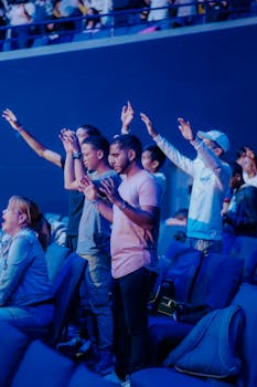 Diverse crowd enjoying a live music concert, sharing excitement and energy indoors.