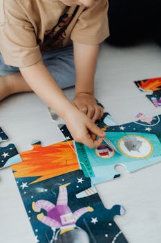 Young child enjoying a colorful space-themed puzzle, fostering creativity and play.