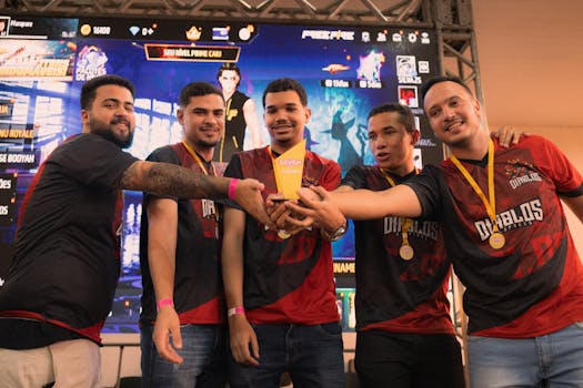 A group of gamers celebrating their victory at an e-sports event holding a trophy.