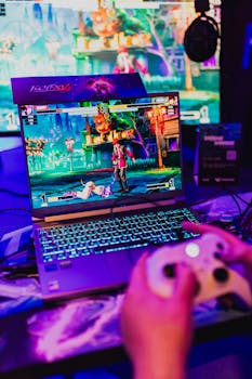 Colorful gaming scene on a laptop with controller, perfect for entertainment visuals.