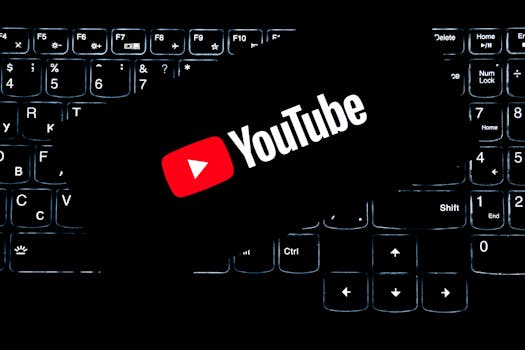 YouTube logo displayed on a backlit keyboard, representing digital media and online content creation.